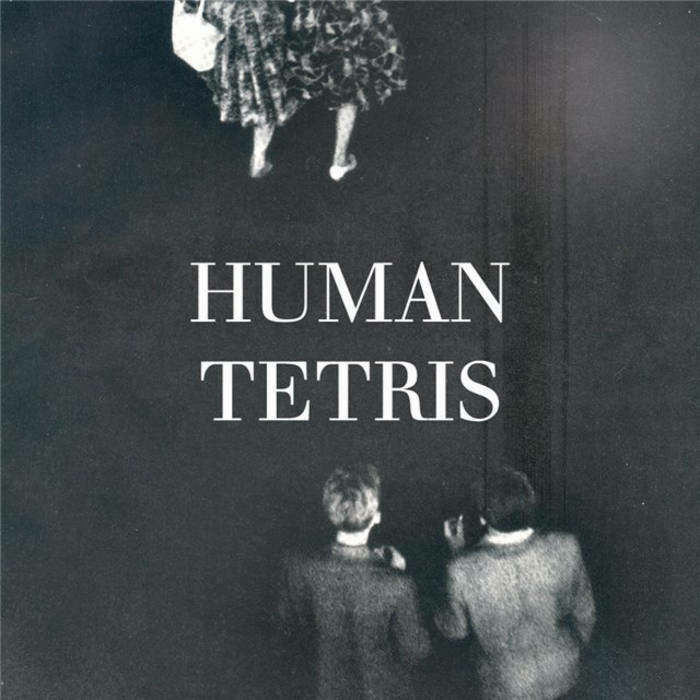 Human Tetris EP cover artwork: Bandname written on a dark grey surface, three people seen from above.